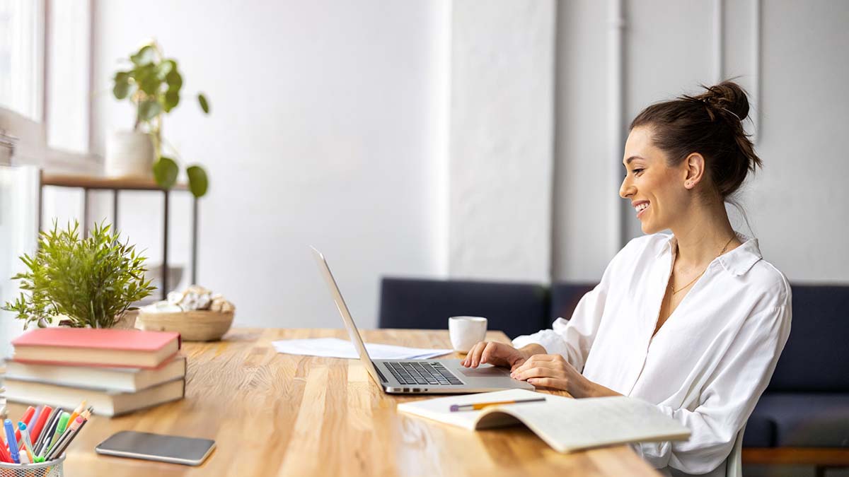 Woman Smiling And Working At Home