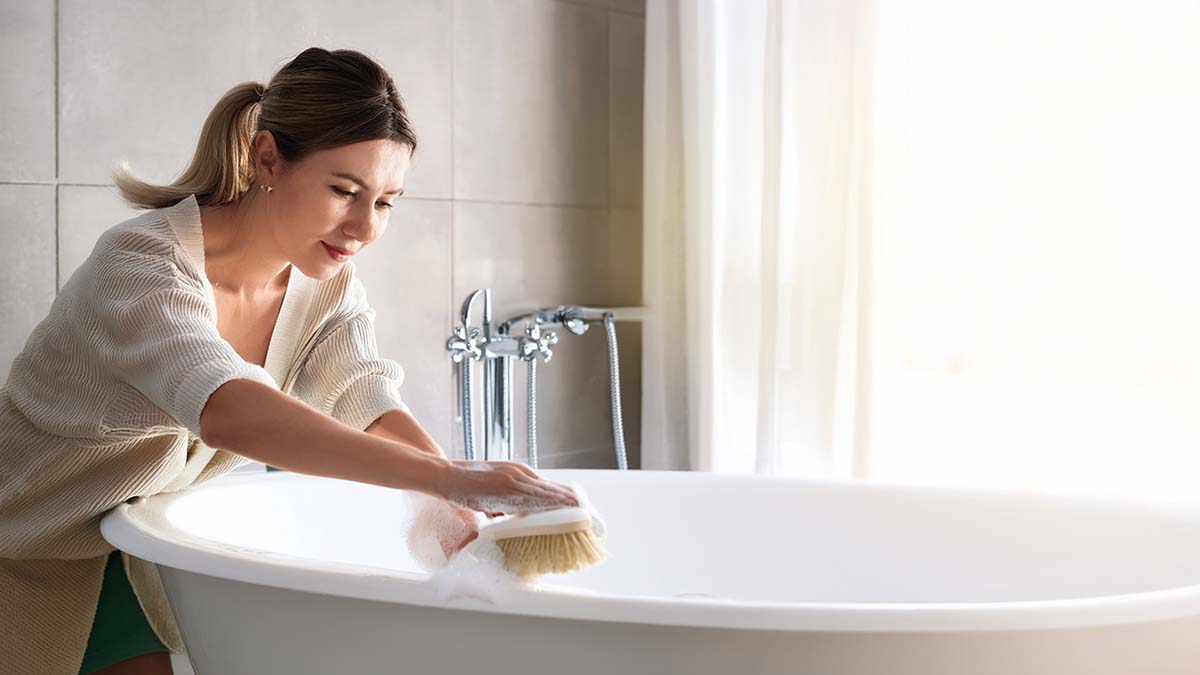 Woman Cleaning Bathtub