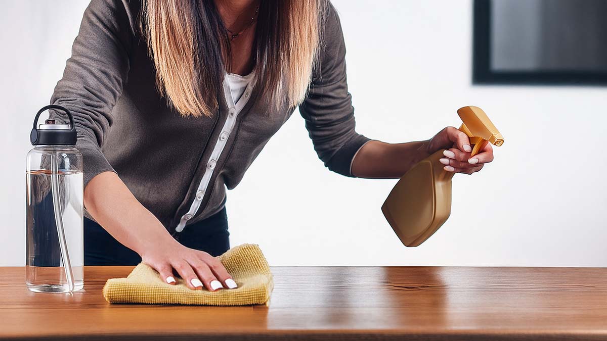 Woman Cleaning While Staying Hydrated