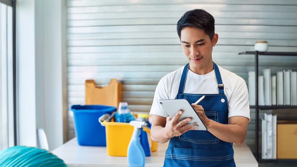 Man Cleaning With Checklist
