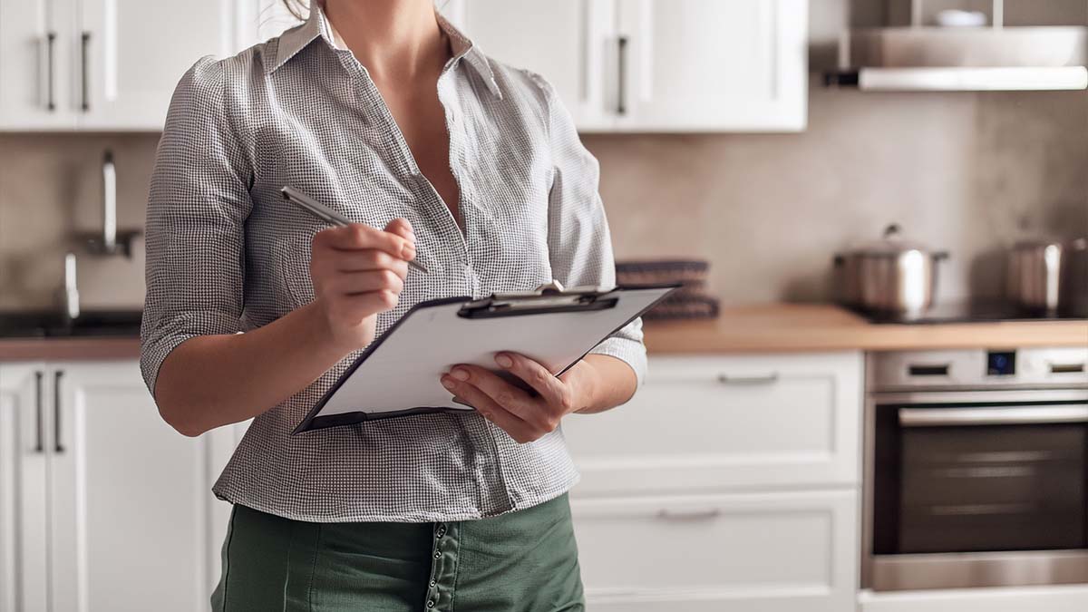 Woman Using Cleaning Checklist