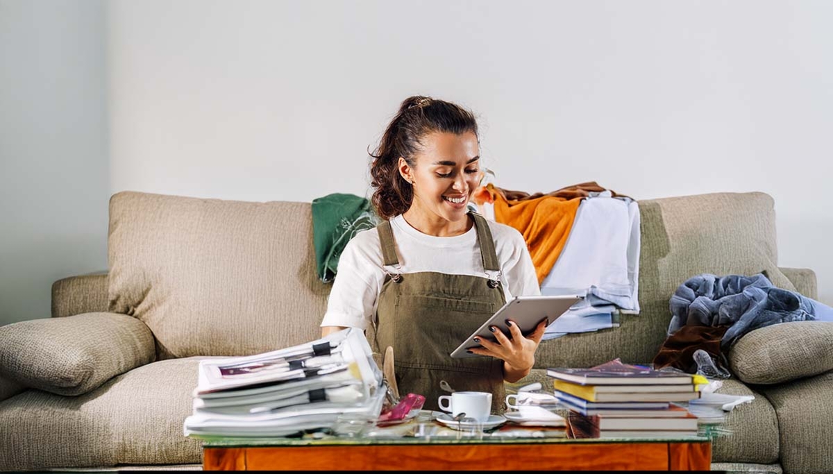 Woman With Tablet Amid Clutter